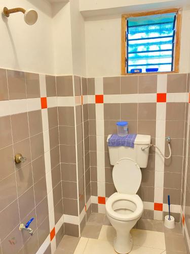 a bathroom with a toilet and a shower at Serene One Bedroom in Ukunda
