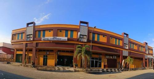 an orange building with colorful windows on a street at Codidik Hotel in Kuantan