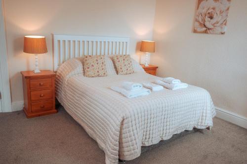 a bedroom with a bed with towels on it at Plas Gorwelion guest house - Adult only in Llandudno