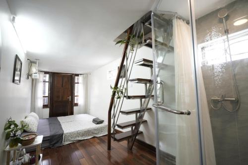 a bathroom with a ladder next to a bedroom at Bu House Hanoi Old Quarter in Hanoi