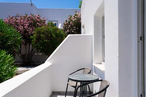 a small table and chair sitting on a balcony at Albatros Hotel in Karterados