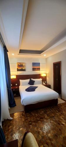 a bedroom with a large white bed in a room at Omedad Hotel in Dirē Kʼalu