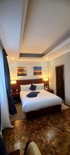 a bedroom with a large bed in a room at Omedad Hotel in Dirē Kʼalu