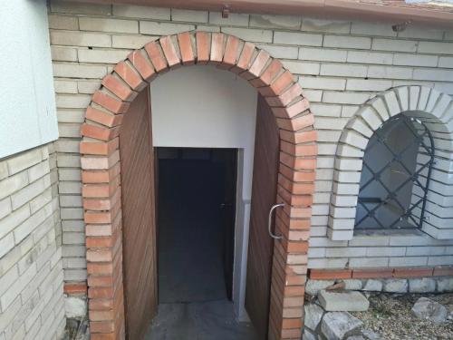 an archway in the side of a brick building at Sluneční villa Terezka Lednice ,penzion pro skupiny se snídaní,degustací vín in Lednice