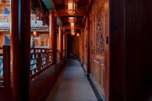 a hallway in a building with wooden walls at Spirited Silky Inn丨Dali Old City in Dali