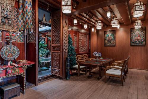a dining room with a table and chairs at Spirited Silky Inn丨Dali Old City in Dali