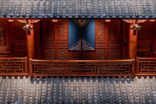 a view of a stage with wood paneled walls and benches at Spirited Silky Inn丨Dali Old City in Dali