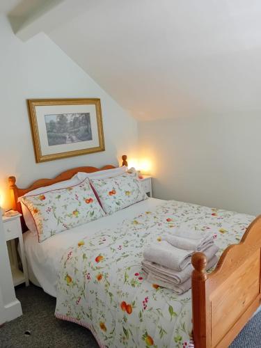a bedroom with a bed with towels on it at The Shepherd's Cottage in Ardmore
