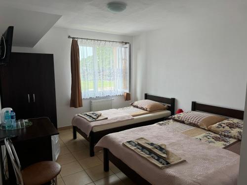 a room with two beds and a window at Willa Aleksander in Rowy
