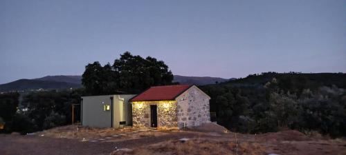 a small chapel with lights on top of a hill at Terras do Salvado Agroturismo in Fundão