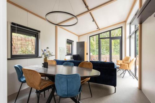 a dining room with a table and chairs at Prinsenweg 1 tm 4 in Nijkerk