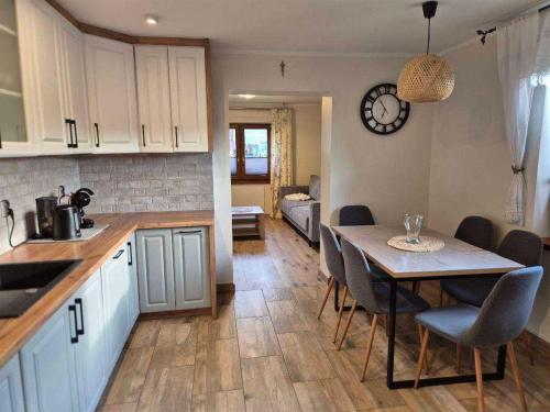 a kitchen and dining room with a table and chairs at Apartamenty u Ptaszka in Zakopane