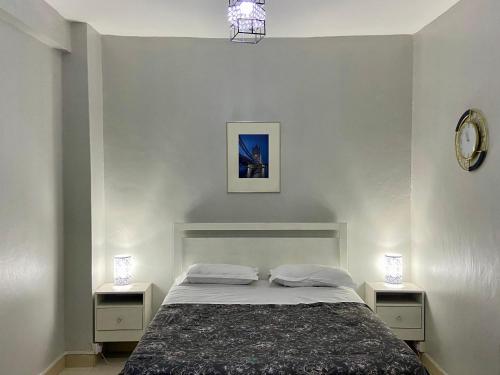 カンパラにあるKampala city center vin havenのベッドルーム1室(ナイトスタンド2つ、ランプ2つ付)