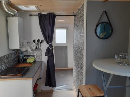 a small kitchen with a table and a window at Les Ecogîtes de la sablière bulle géodésique in Oucques