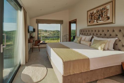 a bedroom with a large bed with a large window at Villa KIM in Momjan