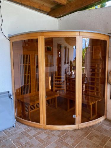 a large glass room with a table and chairs at Haus Zimba Ferienwohnung am Bartholomäberg in Bartholomäberg