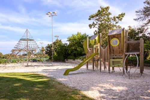 a playground with a slide in a park at Vilalara Grand Hotel Algarve in Armação de Pêra