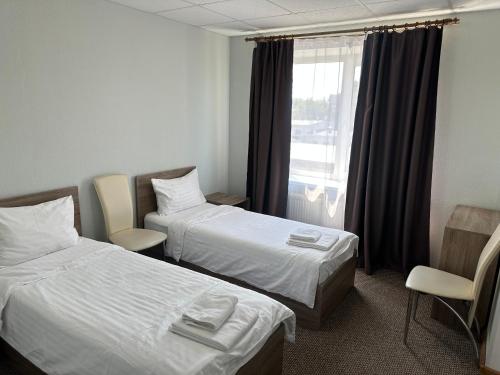 a hotel room with two beds and a window at Yavir in Poltava