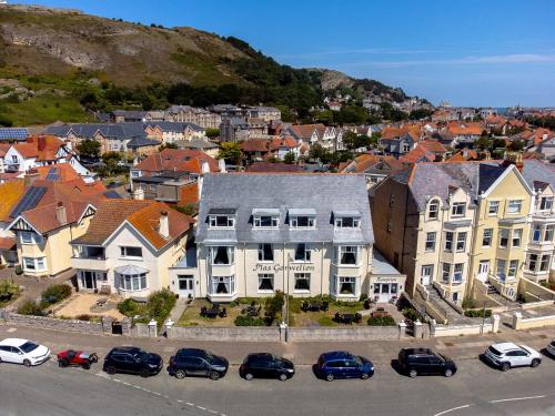 a city with houses and cars parked in a parking lot at Plas Gorwelion guest house - Adult only in Llandudno
