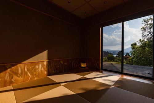 a room with a large window with a view at Villa Yamagara with lake view in Fujikawaguchiko