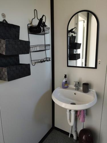 a bathroom with a sink and a mirror at Entire house for rent in Grebaštica