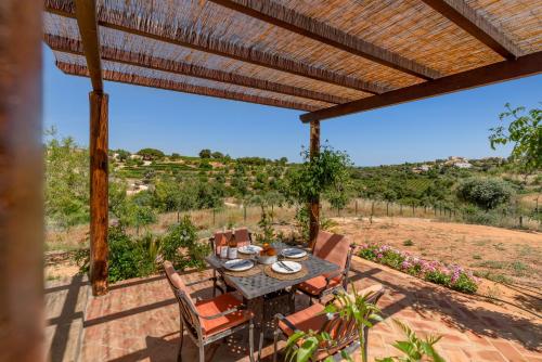 a table and chairs on a patio with a view at Casa Esmeralda - Vineyard View in Porches