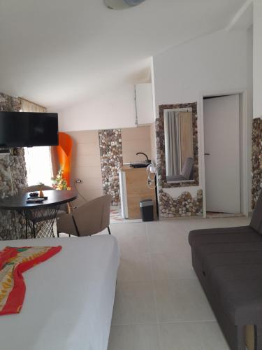 een kamer met een bed, een tafel en een bank bij Vila Verica M in Kravlja