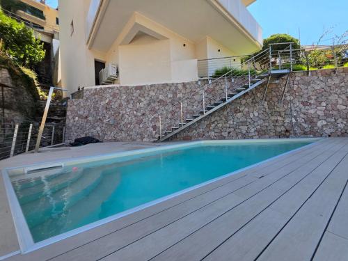 a swimming pool in front of a house at Casa DiMa - La Pigna Verde in Taormina