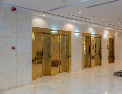a row of glass doors in a building at فندق برادايس لاند الزهراء Paradis Land Hotel ALzhra in Az Zahrāʼ