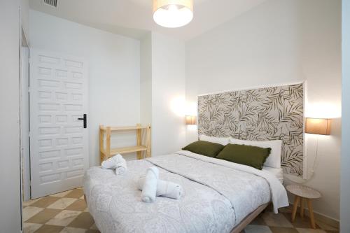 a bedroom with a bed with two teddy bears on it at ADANAR-Las Columnas in Granada