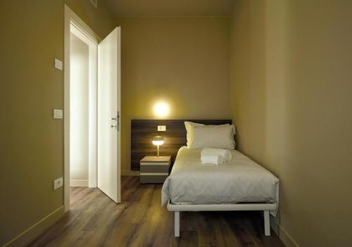 a bedroom with a bed with a lamp on it at The School Venice, boutique Loft in Venice
