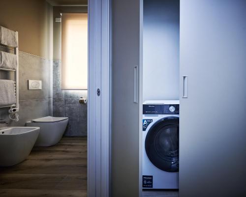 a bathroom with a washing machine and a toilet at The School Venice, boutique Loft in Venice