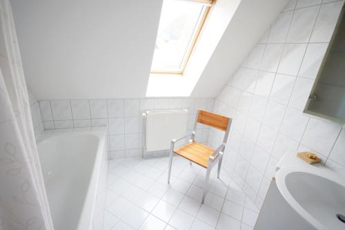 a small bathroom with a chair and a sink at Apartment Mair in Judenburg