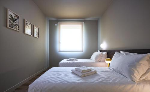 a bedroom with two beds and a window at The School Venice, boutique Loft in Venice