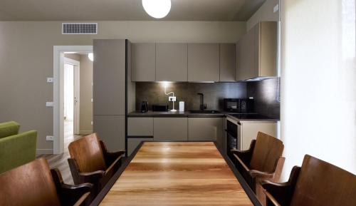 a kitchen with a long wooden table and chairs at The School Venice, boutique Loft in Venice