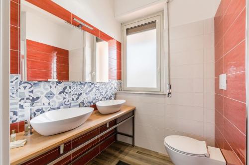 a bathroom with two sinks and a mirror at Suite Giulia - Luxury apartment in the heart of Giarre in Giarre