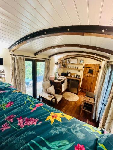 een slaapkamer met een bed en een bureau in een kamer bij The Railway Carriage - Blue in Glasbury