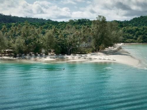 a beach with a group oficans on the water at The Survival by Seudam in Ko Kood