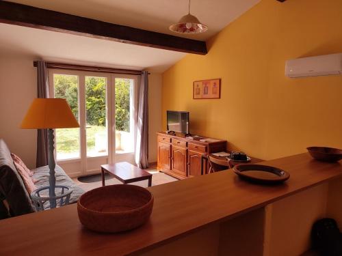 a living room with yellow walls and a table at Domaine Guiton Cerise noire in Chamaret