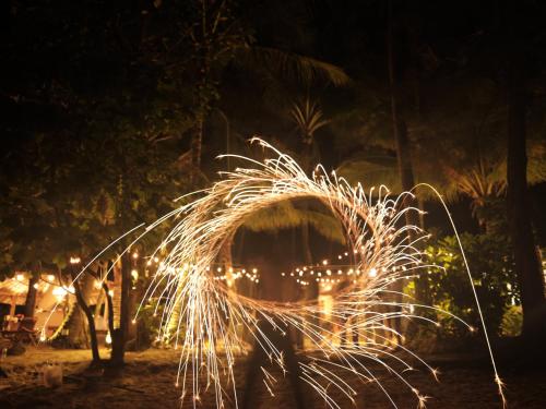 a pile of sparklers in the dark at night at The Survival by Seudam in Ko Kood