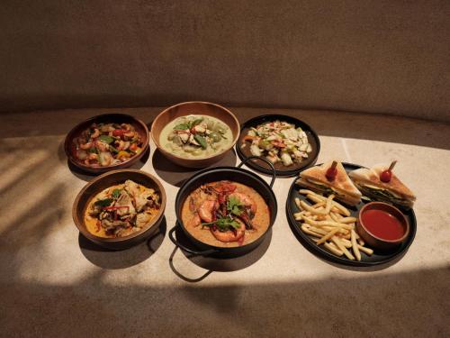 a group of different dishes of food on a table at The Survival by Seudam in Ko Kood