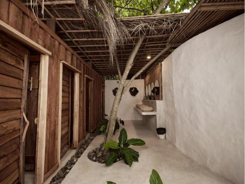 a house with a tree in the middle of a hallway at The Survival by Seudam in Ko Kood