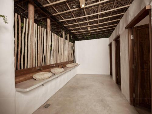 a room with a row of hats on the wall at The Survival by Seudam in Ko Kood