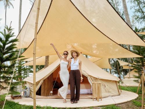 two women standing in front of a tent at The Survival by Seudam in Ko Kood