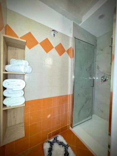 a bathroom with a shower and some towels at La Dolce Sosta in Rocchetta Tanaro