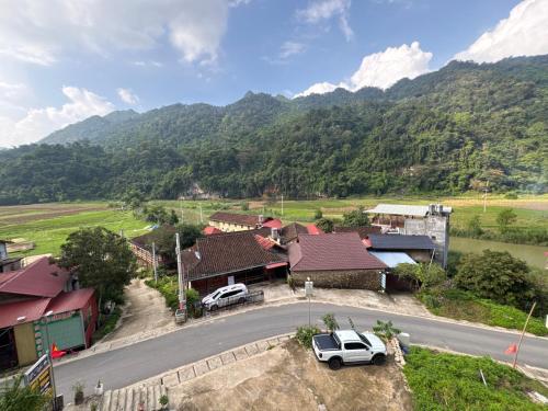 an aerial view of a village with a mountain at Ba Be Lake - Nhà Nghỉ Thư Nhạc in Bak Kan