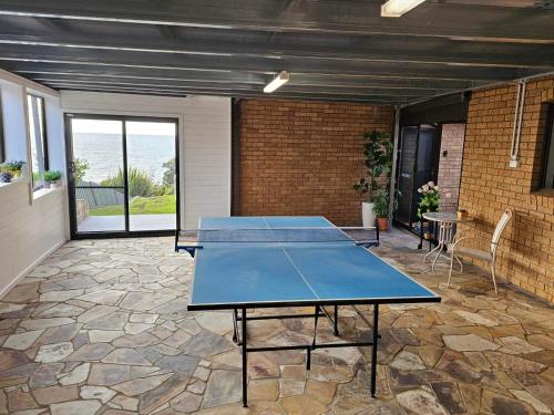 a ping pong table in the middle of a patio at Friesland by the beach in Somerset