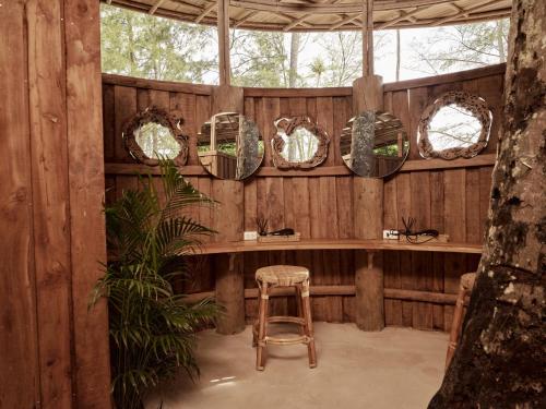 a wooden room with a stool and mirrors at The Survival by Seudam in Ko Kood
