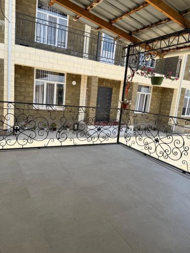 a large patio with benches in front of a building at Asman in Akchiy