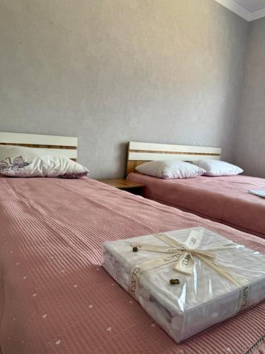 two beds sitting next to each other in a room at Asman in Akchiy